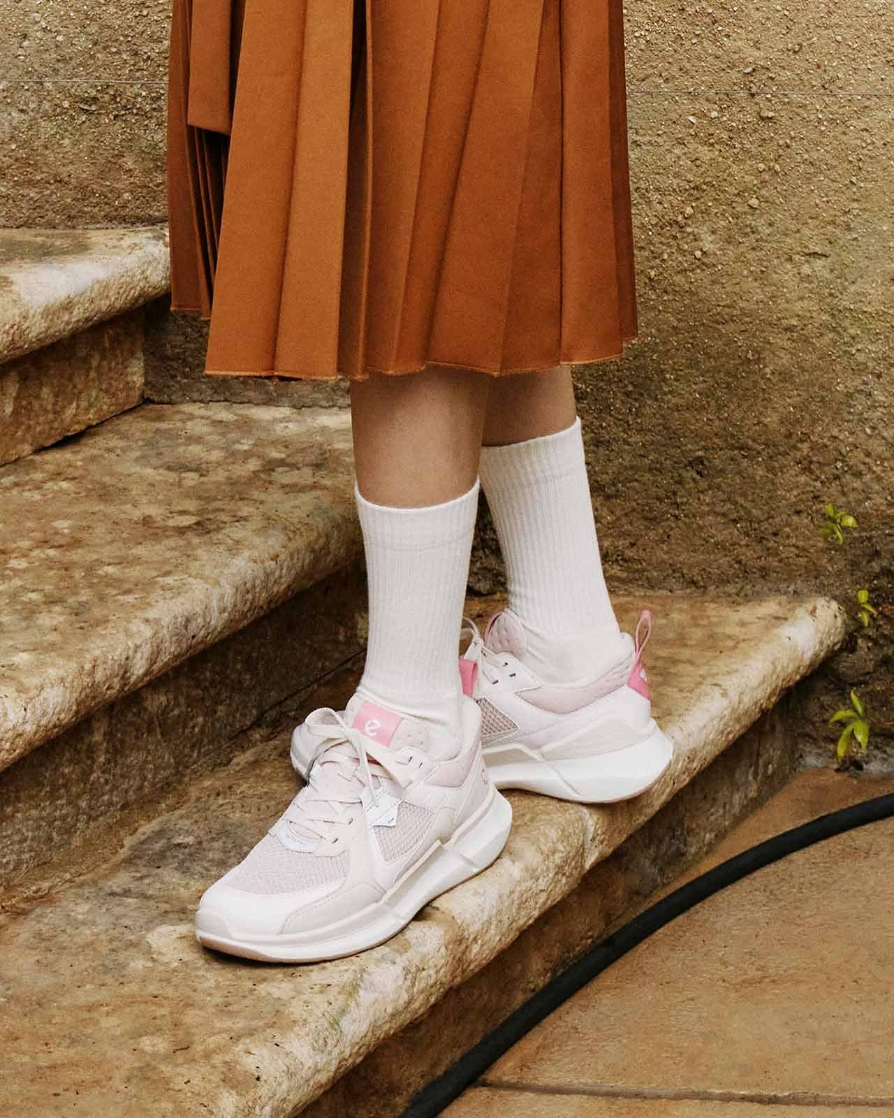 Model standing on outdoor steps