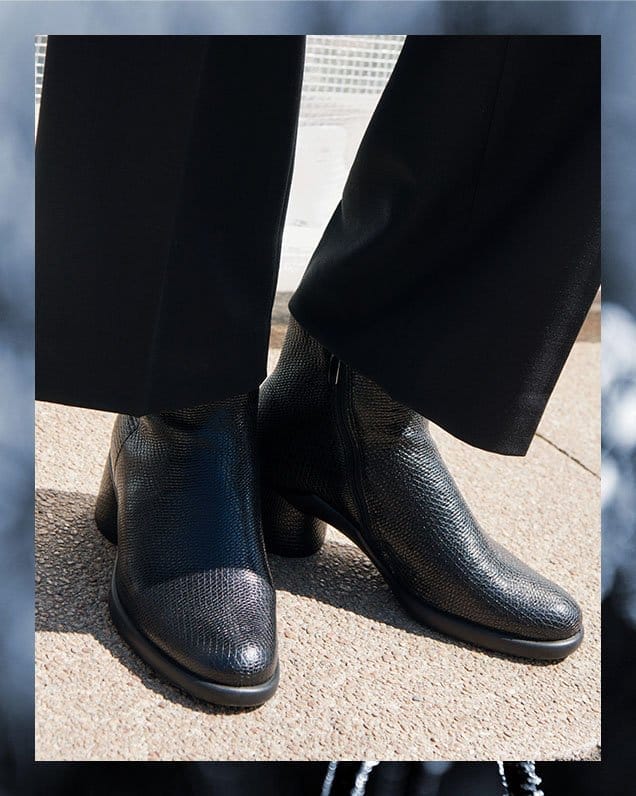 Woman wearing black dress boots