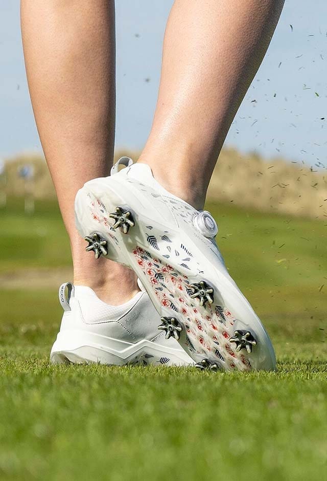 Woman wearing golf shoe