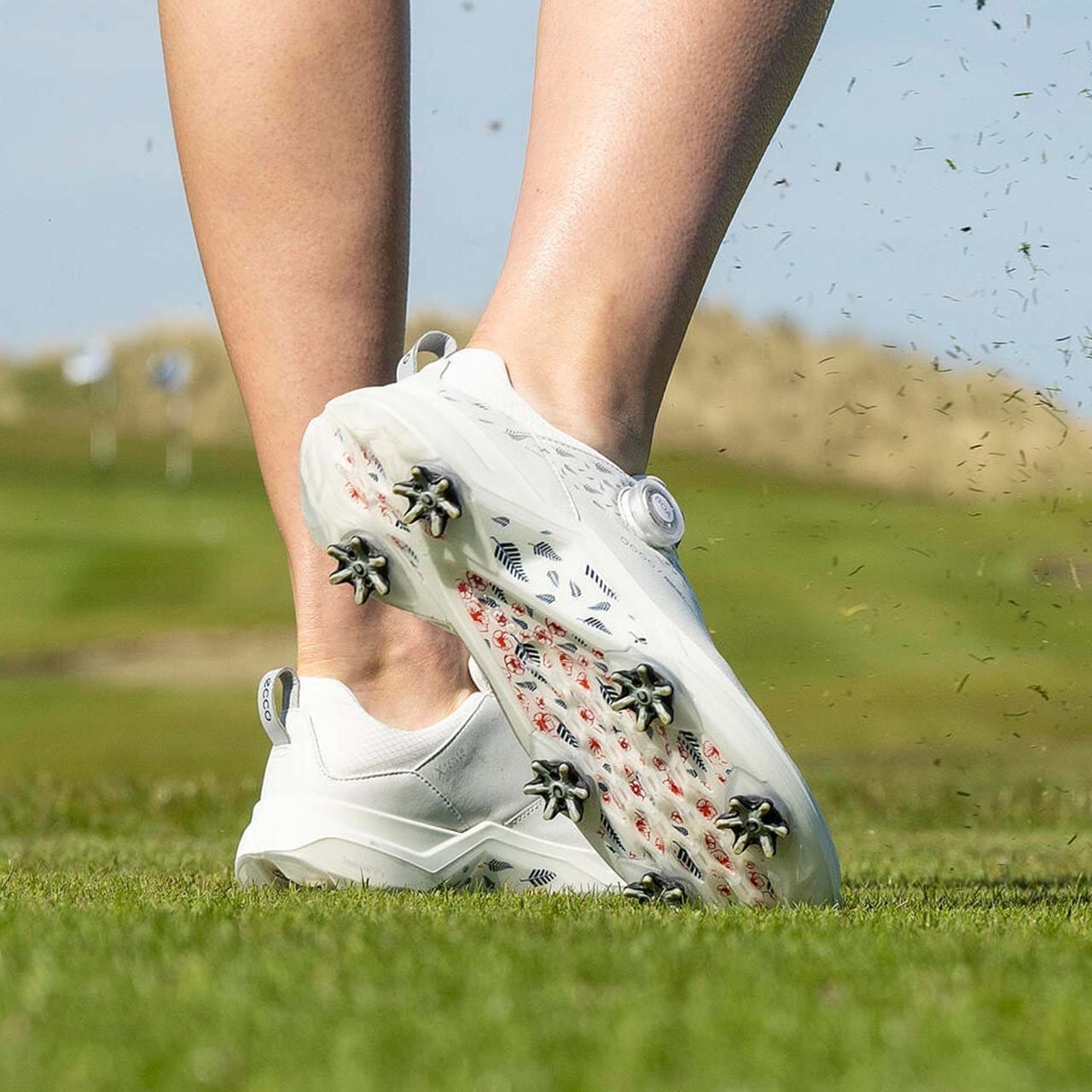 Woman wearing white golf shoes