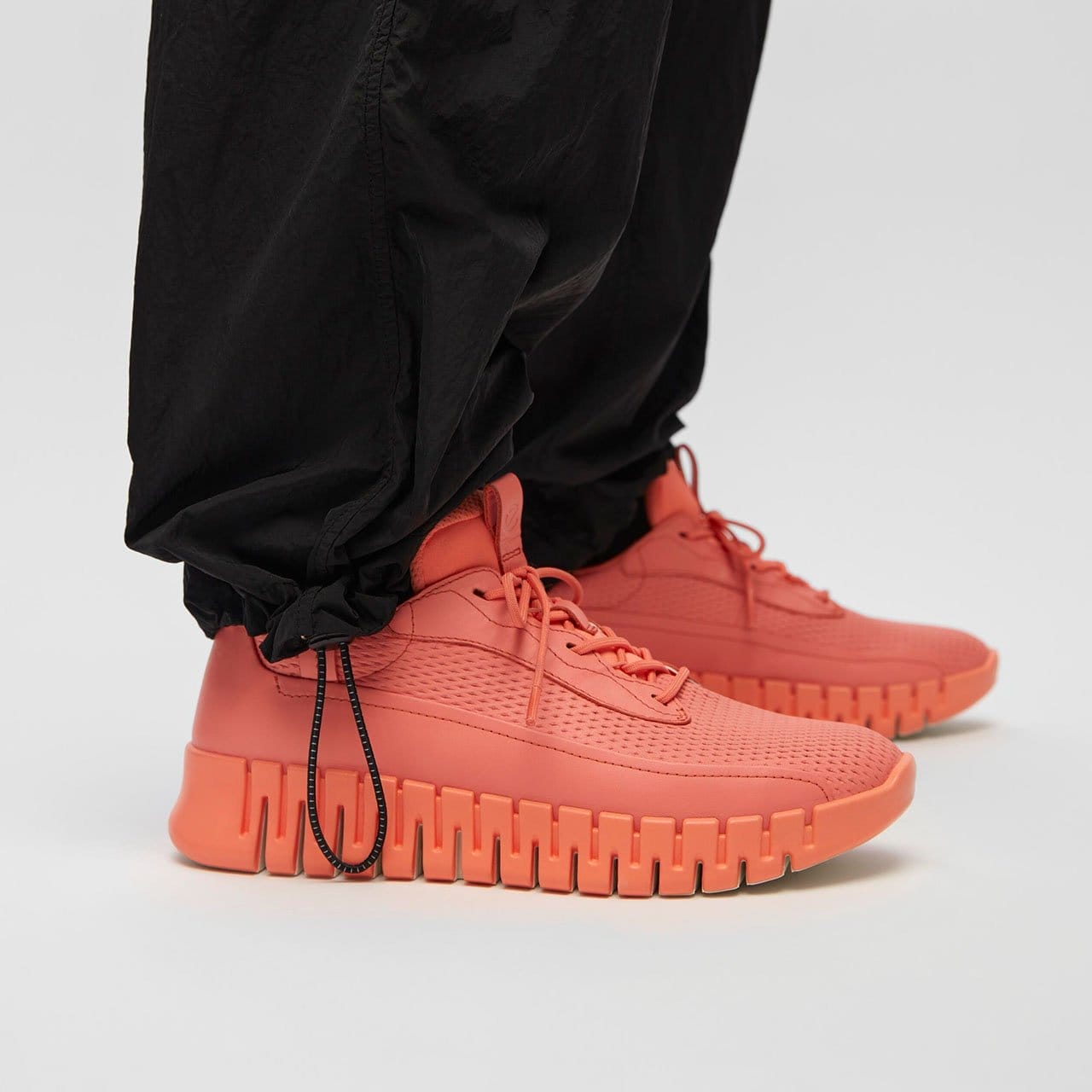 Model wearing orange sneakers