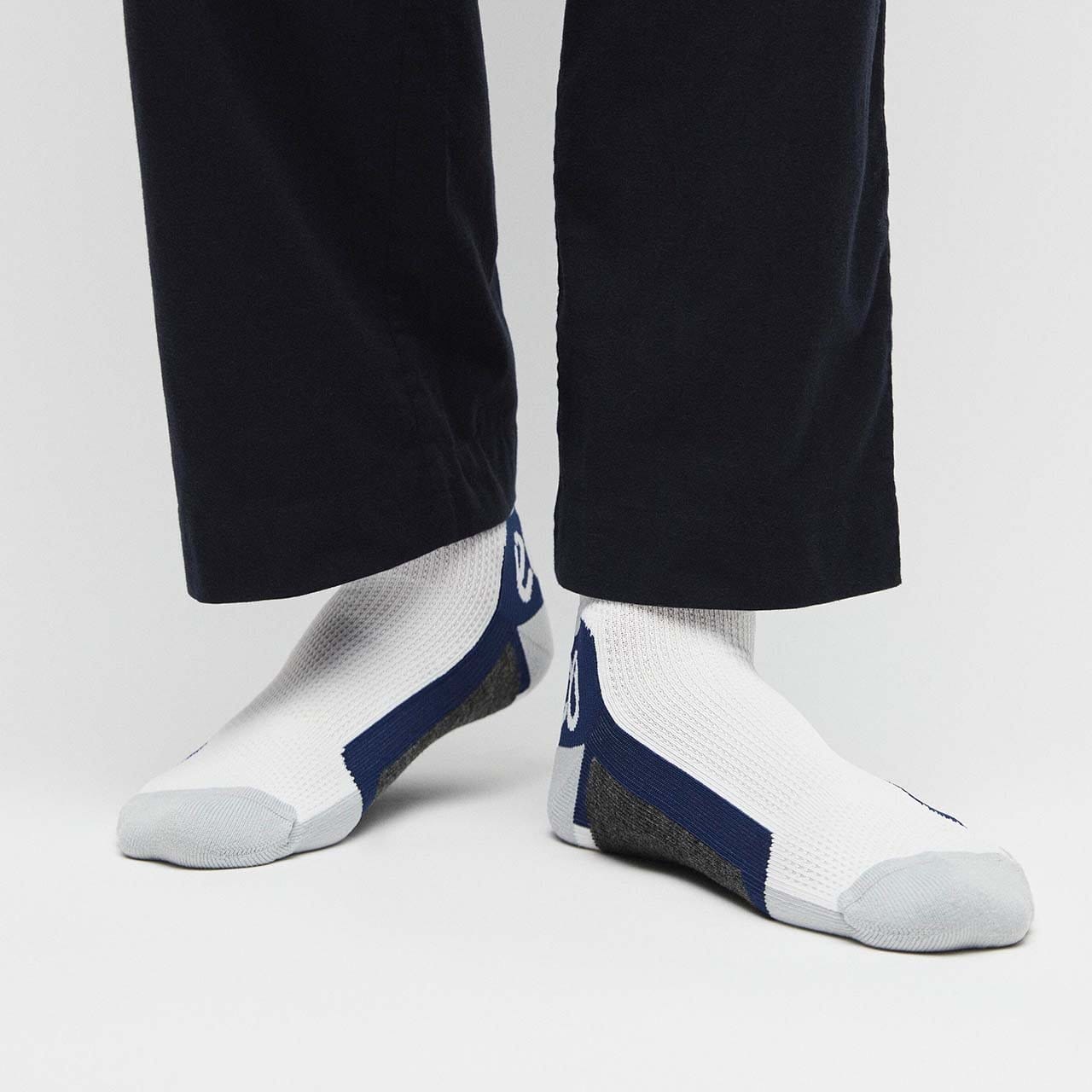 Man wearing white and blue socks