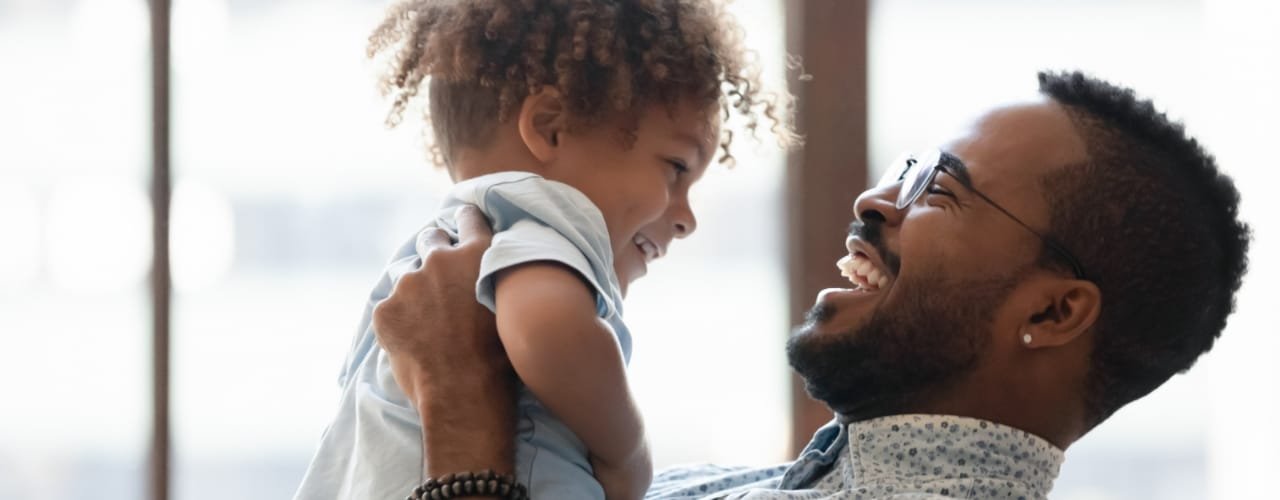 Dad holding up toddler