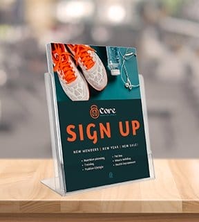 A flyer, custom designed for Core Exercise Studio, displays an image of running shoes. The flyer reads 'SIGN UP.'