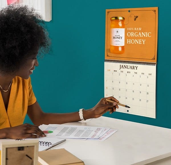 Photo calendar, promoting an organic honey business, hangs in a home office