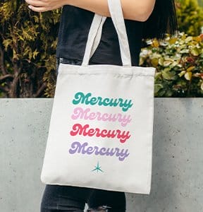 A person holds a stylish branded tote bag.