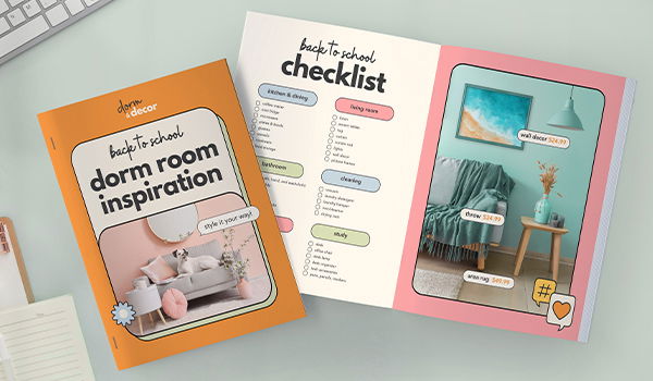 Two custom manuals showcasing dorm room inspiration and a back-to-school checklist sit on a desk.