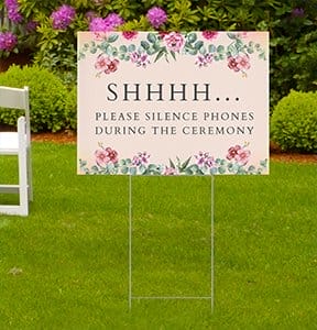 A yard sign reminds wedding quests to silence their phones.