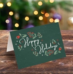 A green holiday card reads “HAPPY HOLIDAYS.”