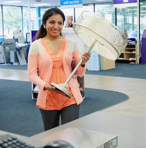 Happy customer with lamp inside FedEx Office.