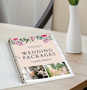 A manual open on a table reads “WEDDING PACKAGES.”