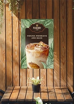 A corrugated plastic sign with a crisp image of a cold beverage reads 'MOCHA MONDAYS ARE BACK' and hangs on a wooden wall.