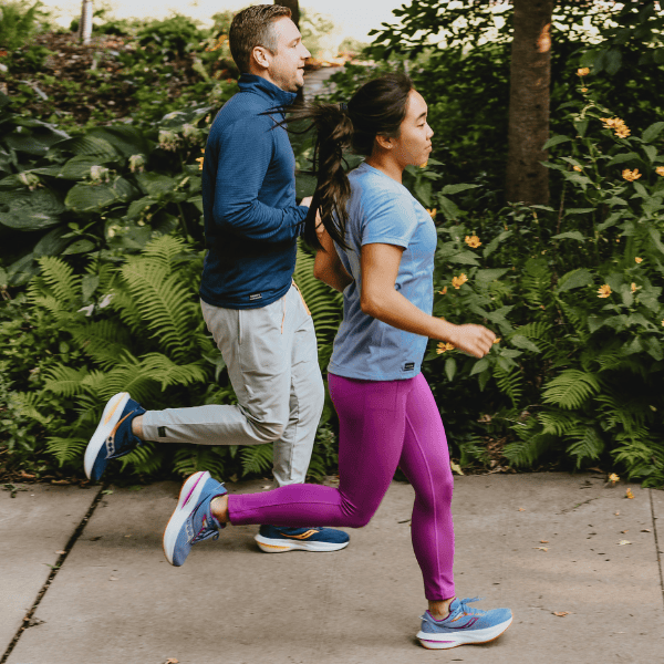 Man and woman running in Saucony gear