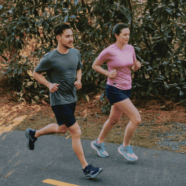 Man and woman wearing Saucony shoes and apparel