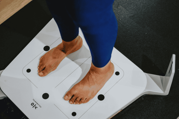 Woman standing on a foot scanner