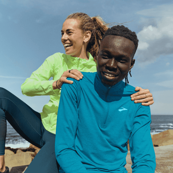 Man and woman wearing Brooks apparel
