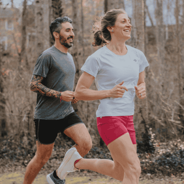 Man and woman running together in ASICS shoes and rabbit apparel
