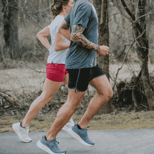 Man and woman running in ASICS shoes