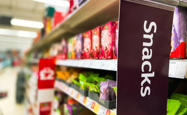 Grocery store snack aisle full of highly processed foods