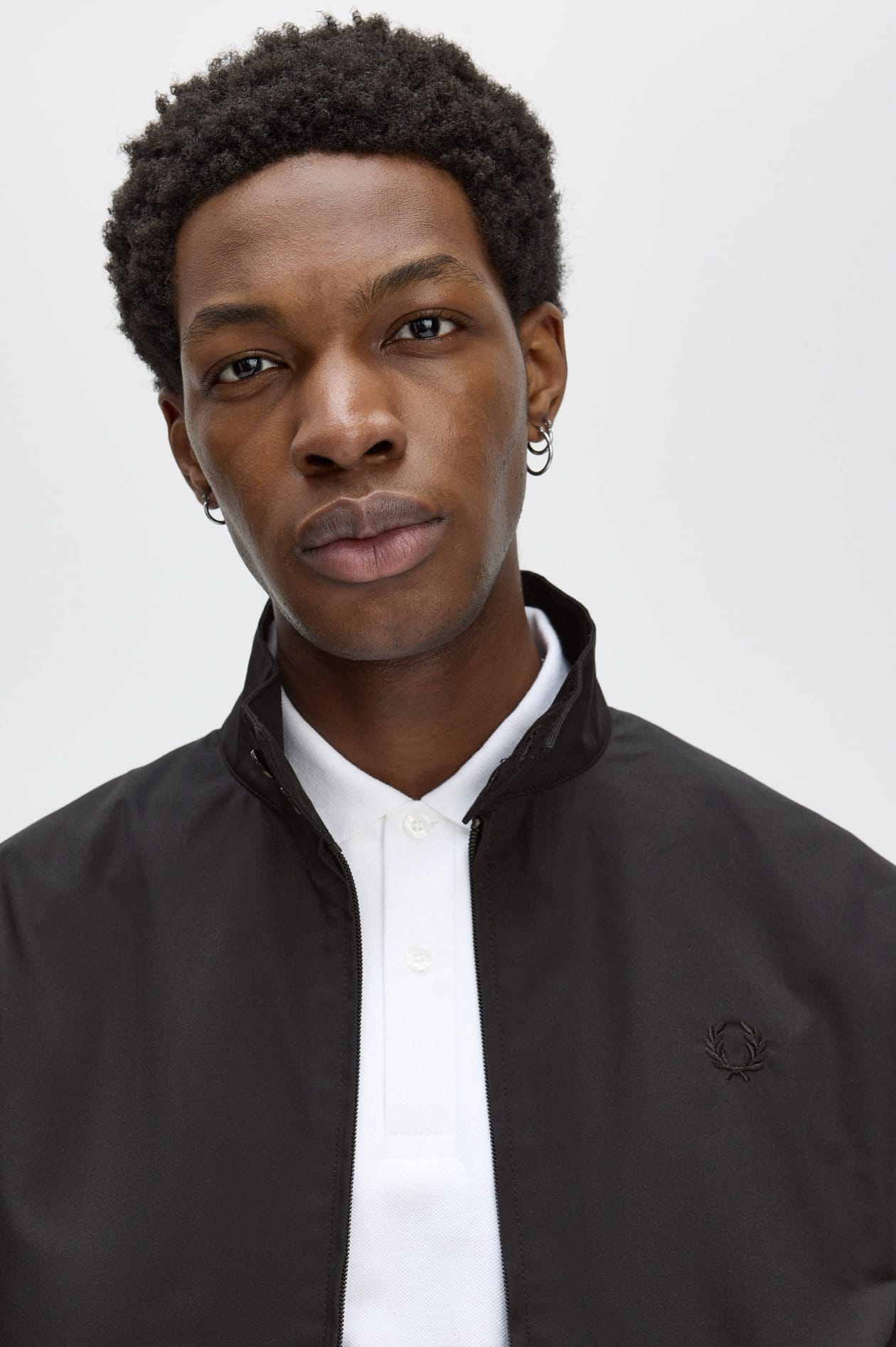 Male model wearing a lightweight Fred Perry Jacket 