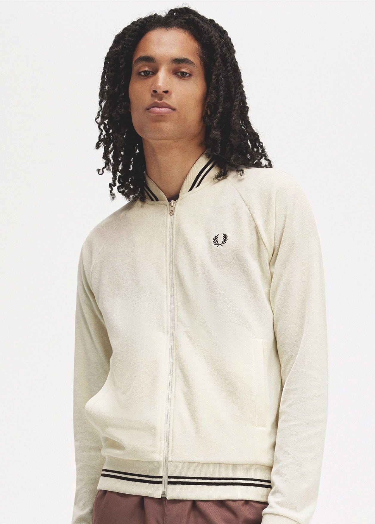 Man wearing zip up ecru bomber jacket