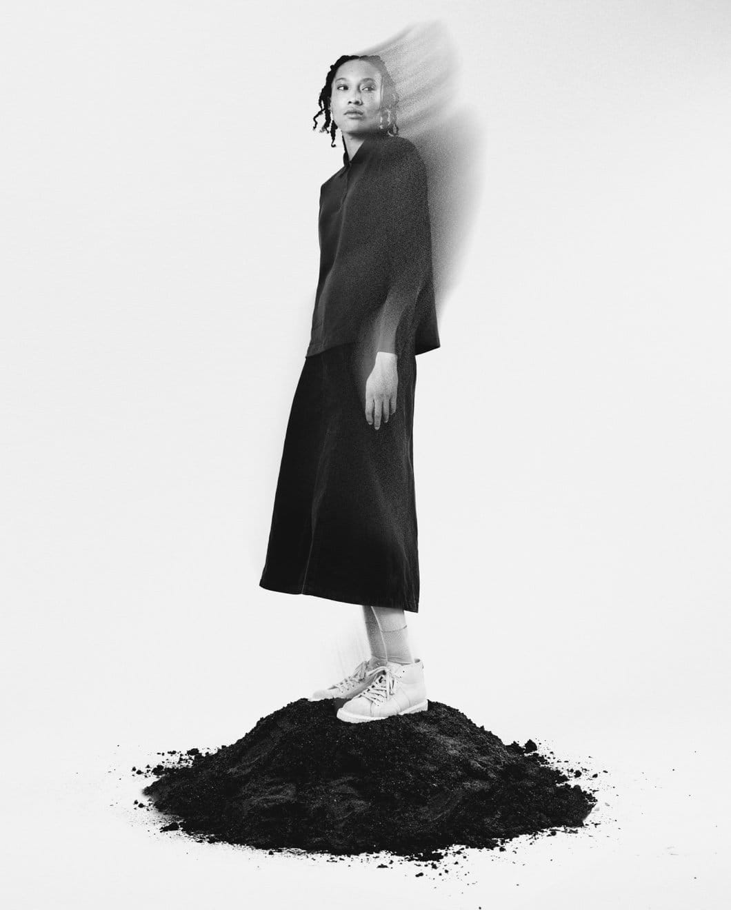 Fred Perry x George Cox - woman standing on pile of dark sand with the shoes on