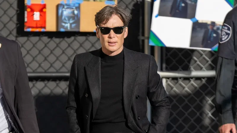 Image may contain: Cillian Murphy, Clothing, Formal Wear, Suit, Adult, Person, Accessories, Glasses, Pedestrian, and Coat