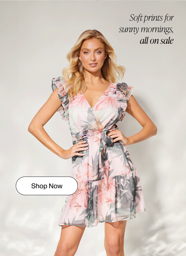 model in a soft pastel palm-printed mini dress with V-neckline and ruffled trim
