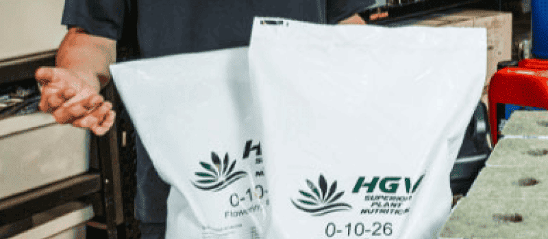 Image of person standing in front of bags of HGV nutrients