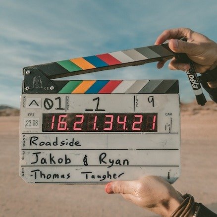 A person holding up a movie clapboard