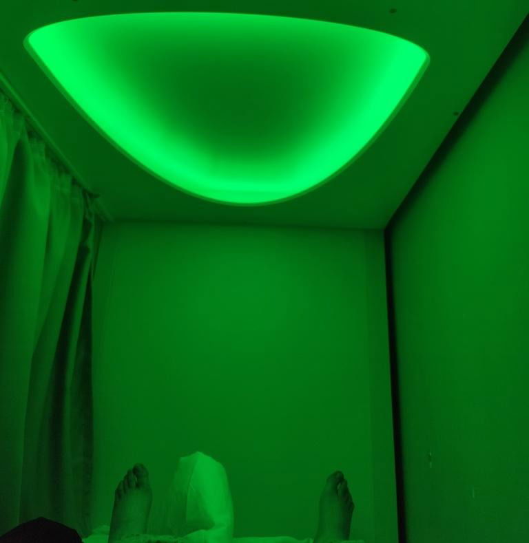 Inside a green cube hostel pod