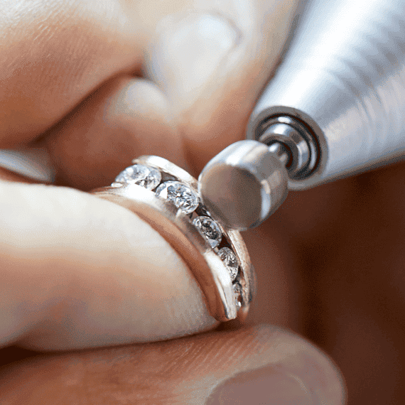 Diamond and gold ring being polished and cleaned