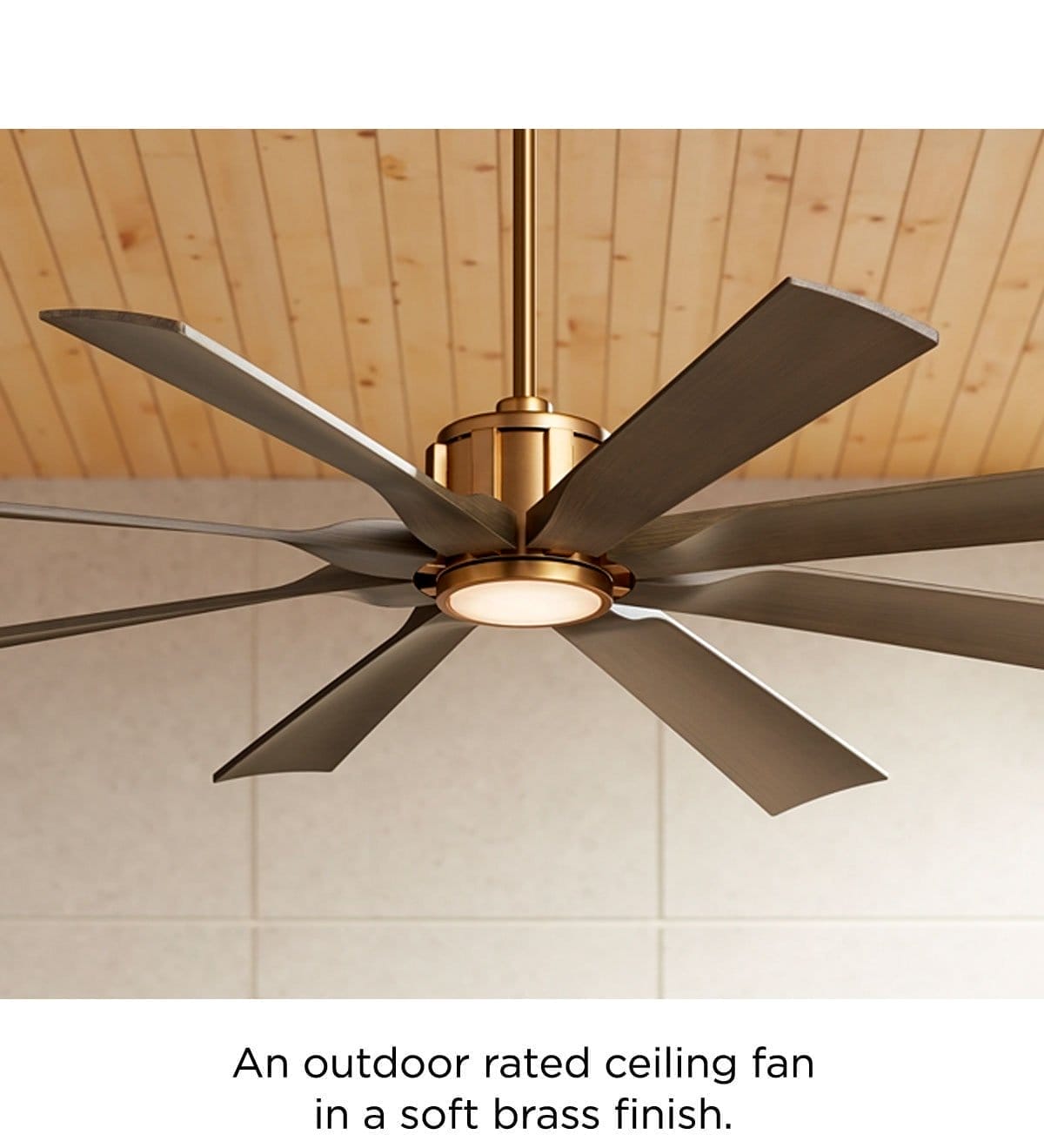 An outdoor rated ceiling fan in soft brass finish.