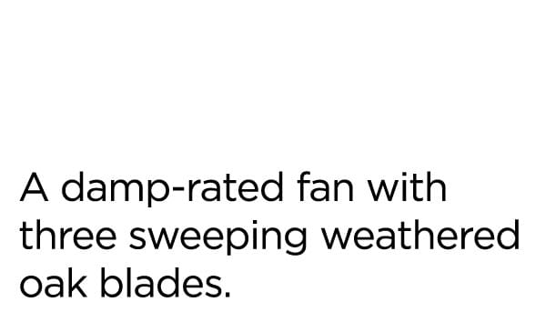 A damp-rated fan with three sweeping weathered oak blades.