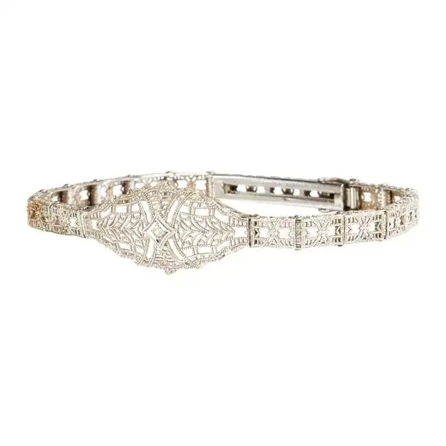 A diamond and 14k white gold bracelet and brooch