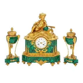 A French Gilt Bronze And Malachite Clock Garniture