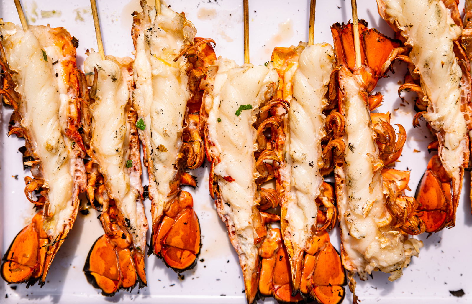 Cooked split lobster tails on skewers