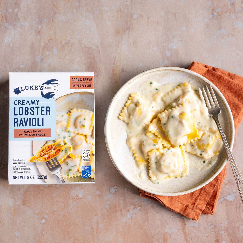 A bowl of Luke's Creamy Lobster Ravioli next to the product box