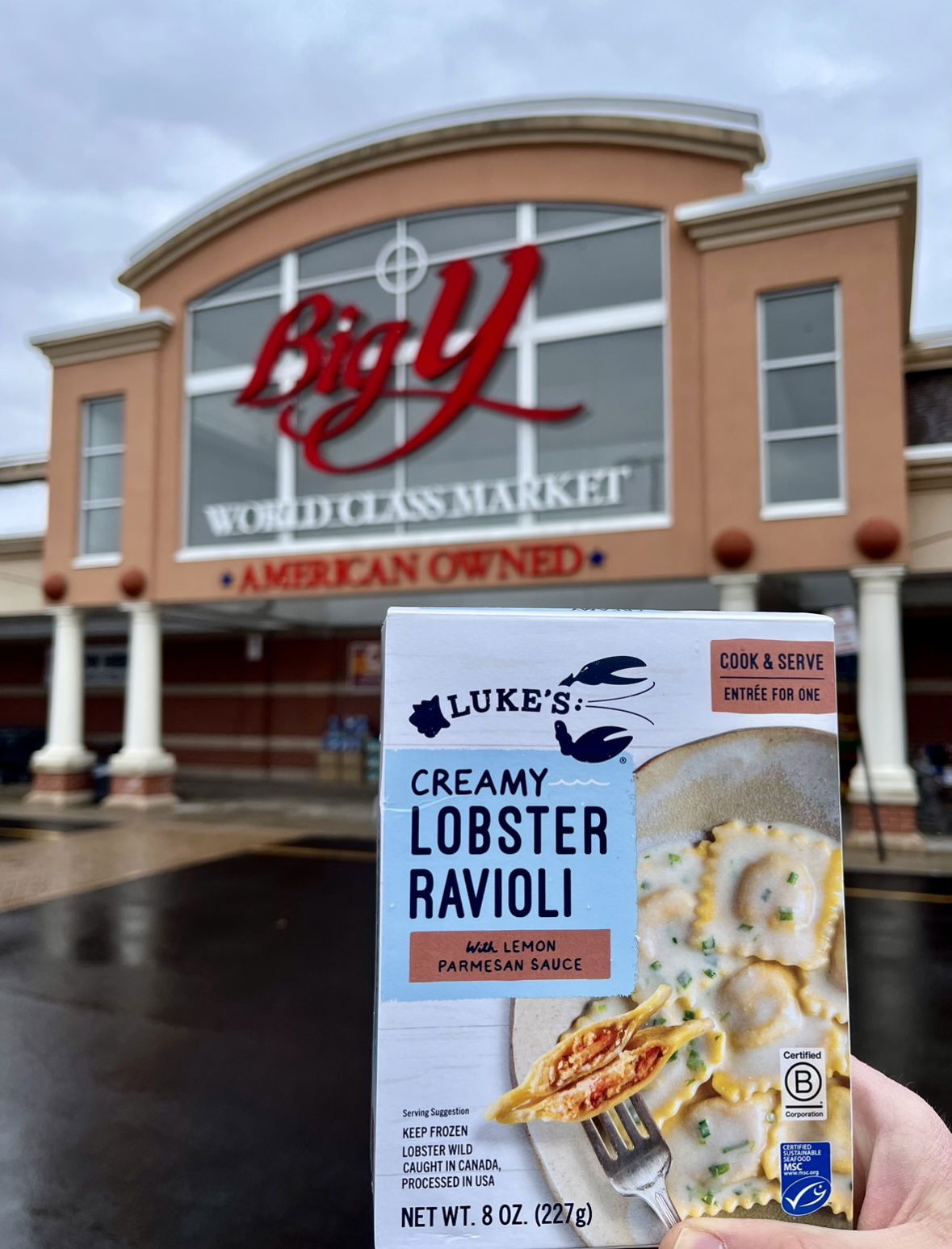 Holding a box of Luke's Lobster Ravioli in front of a Big Y grocery store