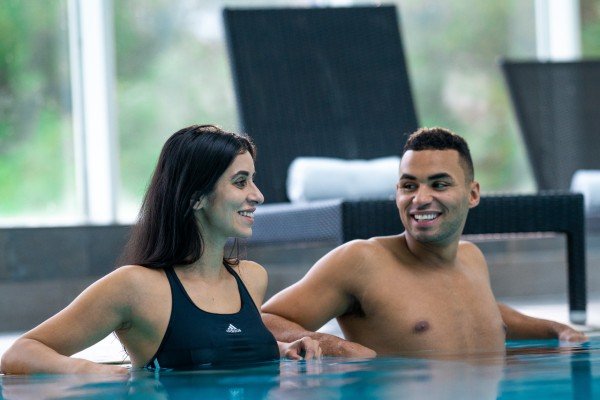 Couple enjoying the pool together on a spa break