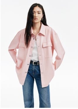 a model in a pink jacket and jeans