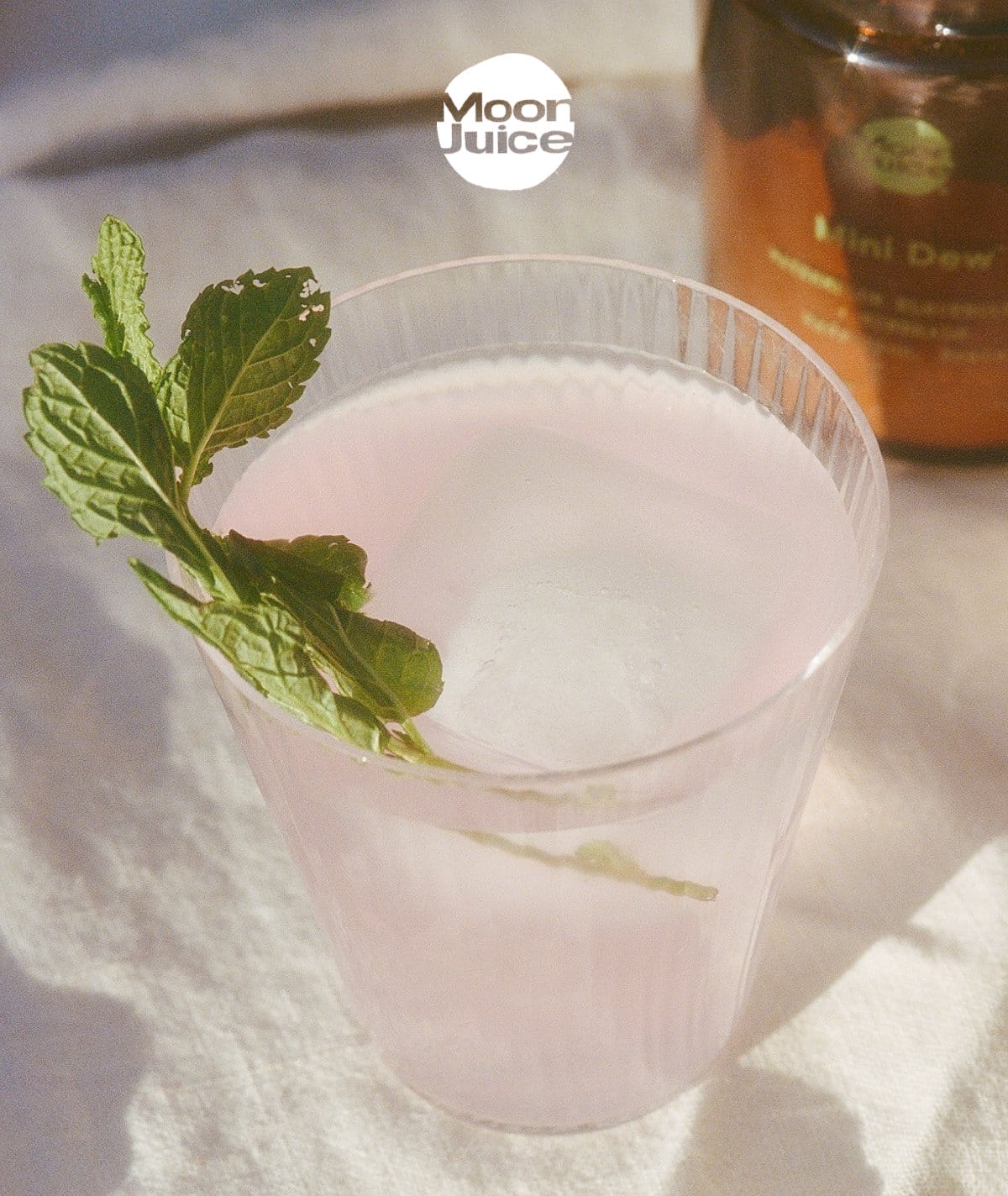 Mojito Dew: Mini Dew Mocktail in a glass with a mint leaf