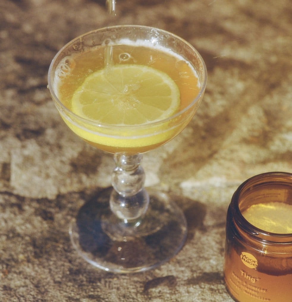 Ting Mocktail in a glass with an orange slice