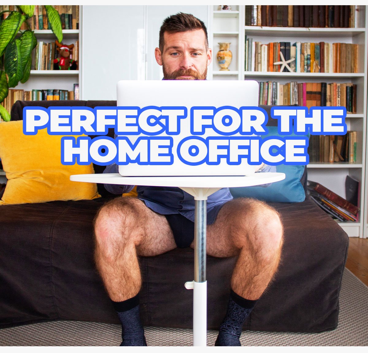 Man in shirt, underwear, and socks with no pants taking a work meeting from his laptop. Perfect for the home office.