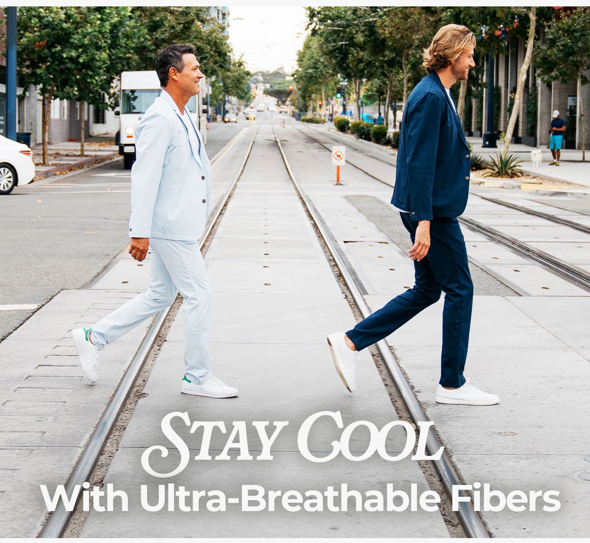 Stay cool with ultra-breathable fibers. Image is two models in the skylines suit and the morgans suit crossing the street.
