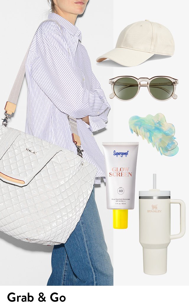 Woman carrying a tote bag next to a baseball cap, sunglasses, claw clip, sunscreen and a water bottle.