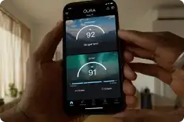 Person wearing Oura Ring while looking at the Oura App on their cell phone
