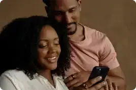 A couple wearing Oura Ring and looking at a cell phone