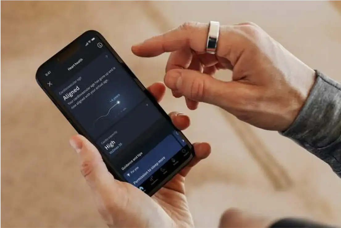 Hands using Oura app wearing Oura Ring
