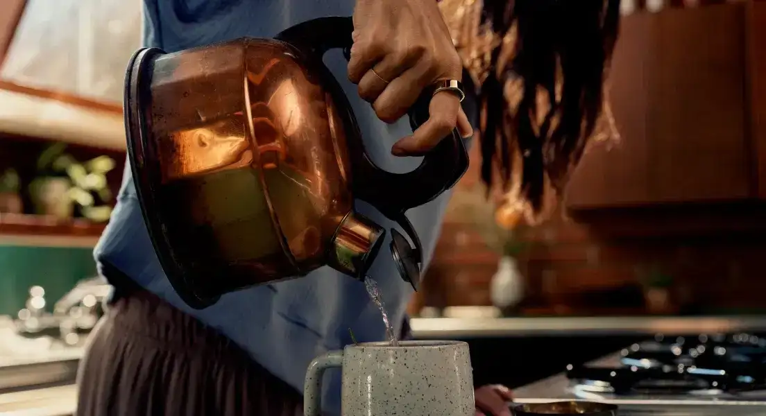 Person Wearing an Oura Ring Making Tea